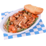 Fish & Shrimp Mexican Style includes 1 Grilled Cod Filet, 6 Grilled Shrimp with the choice of one side, and bread. On a white and blue checkered paper.
