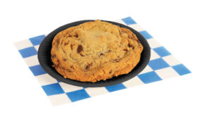 Chocolate chip cookie with pecans n a small black plate
