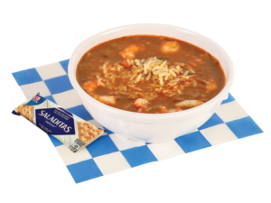 Image of a shrimp gumbo bowl with crackers on a blue and white checkered paper