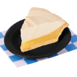 A slice of Lemon Meringue pie on a small black plate. Placed on a blue and white checkered paper.