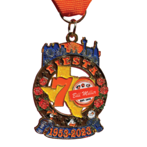 Bill Miller 70th Fiesta medal with Bill Miller animals, roses, stars, the San Antonio skyline, and fireworks.