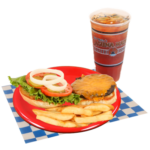 Cheeseburger with fries, lettuce, tomato, pickles, and an iced tea on a white and blue checker paper